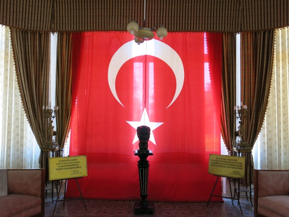 Bust of Ataturk silhouetted against the Turkish flag