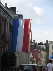 The Dutch flag with an orange pennant at the top. The orange pennant, signifying the House of Orange-Nassau, the Dutch Royal Family, is attached on King's Day and on royal birthdays.